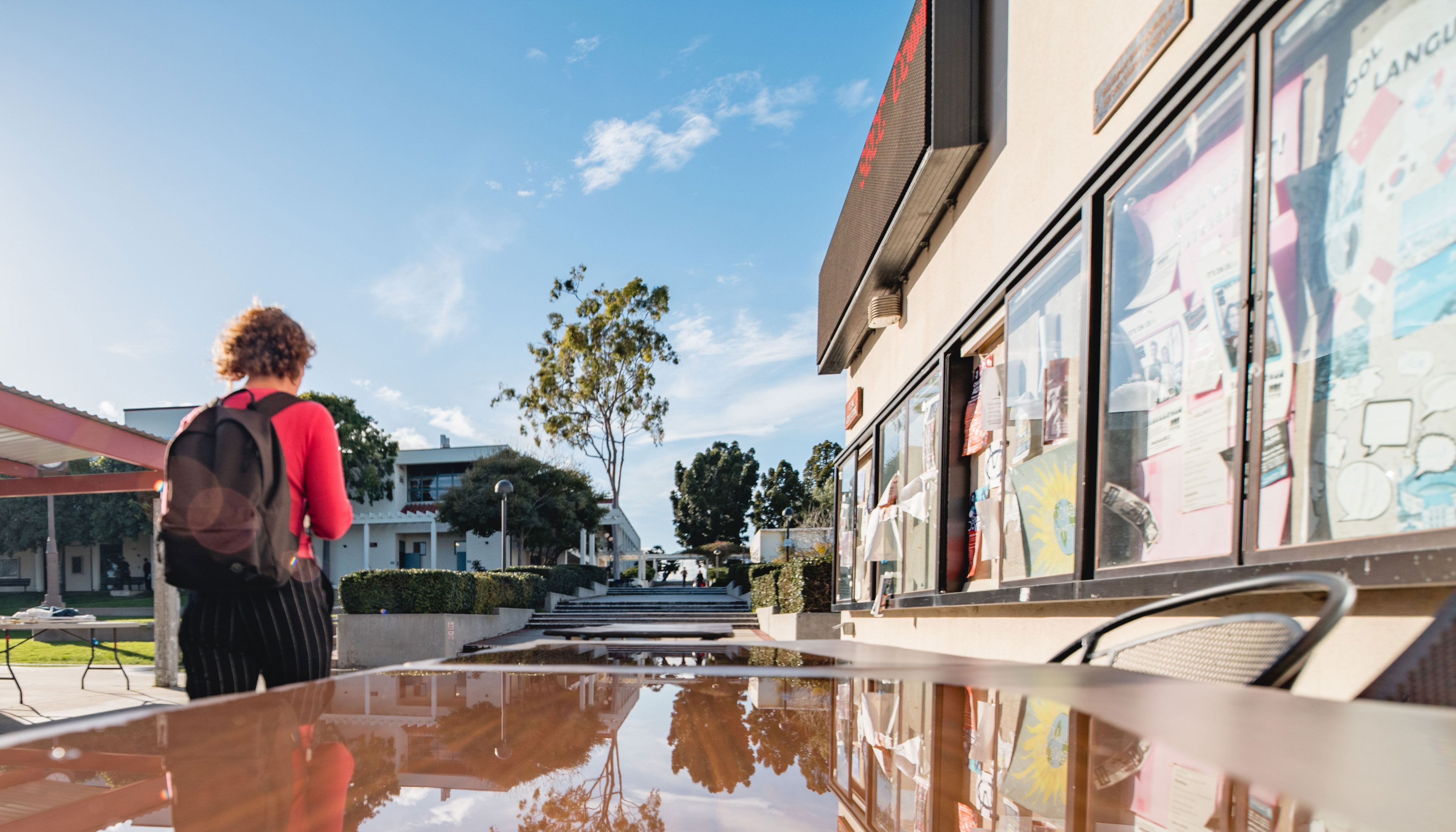 Santa Barbara City College's steps to enrollment for returning students. Photo pictures a student with backpack on.